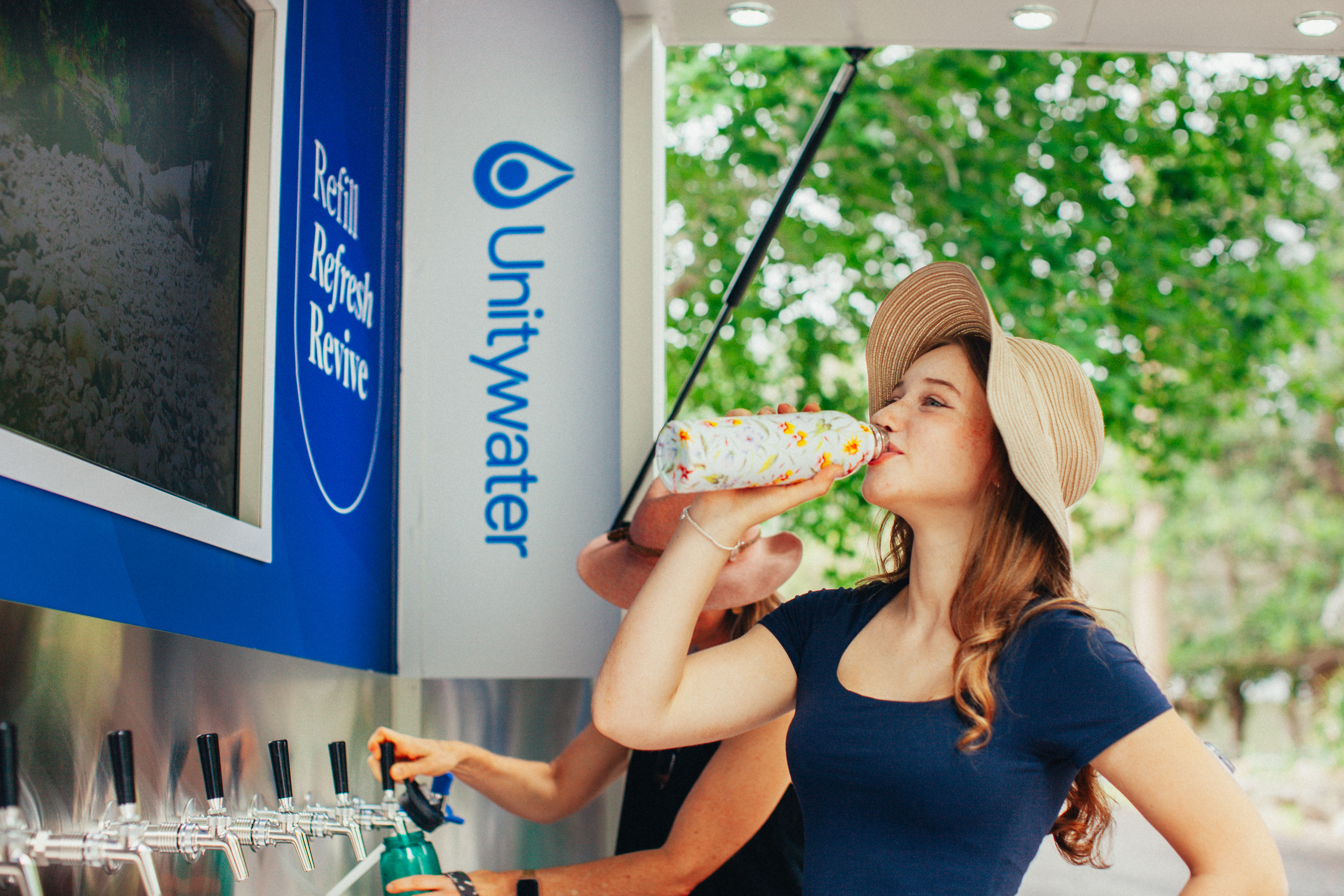 Girl drinking from reusable water bottle