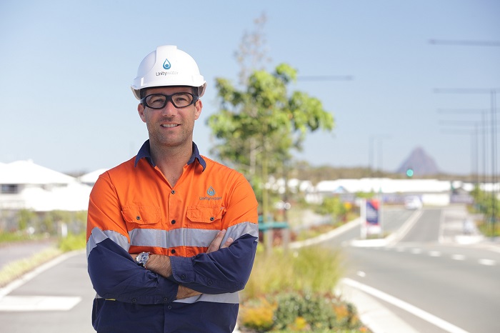 Development services officer standing in front of residential development