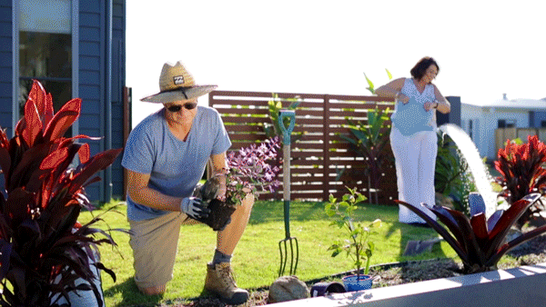 Couple watering garden