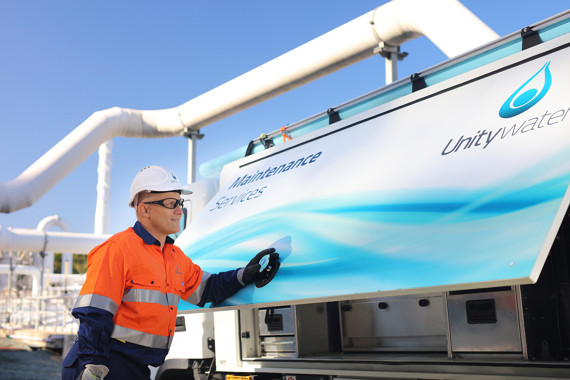 Male Field Crew staff member standing next to Unitywater Maintenance Services Truck