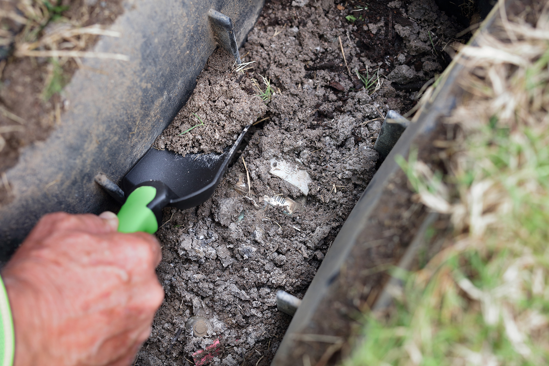 Meter Reader clearing water meter covered with dirt