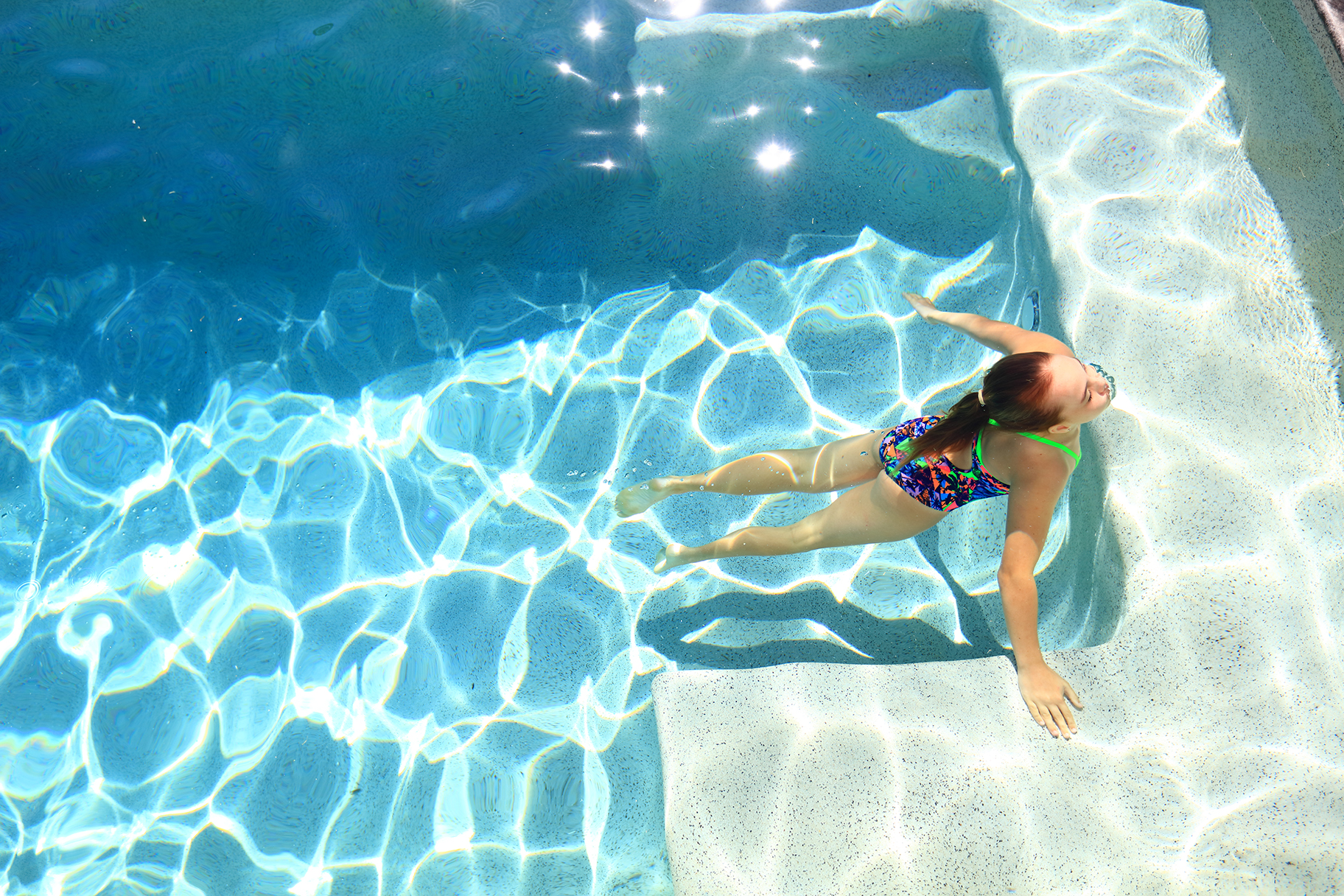 Girl swimming in residential pool