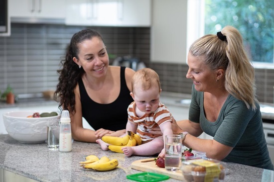 Two Unitywater customers with child at Kitchen bench