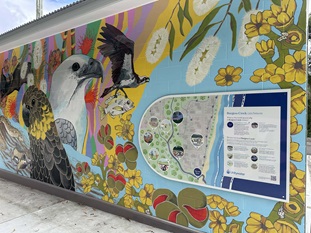 Castaways mural with sign